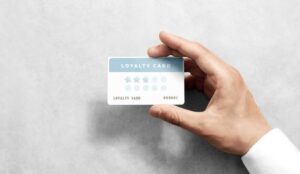 Hand holding a loyalty card with "LOYALTY CARD" text and three filled stars