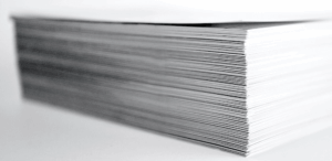 Close-up of a large stack of paper, likely documents or receipts, with visible edges